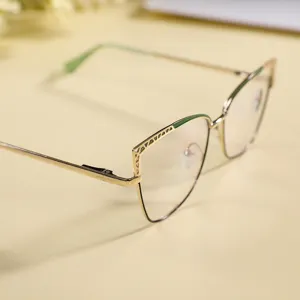 Close-up detail of stylish metal cat-eye anti-blue light glasses with chic gold and green frame.