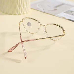 Elegant gold metal cat-eye eyeglasses frame with delicate rhinestone brow details and pink temple tips.
