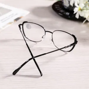 Detail shot of stylish black metal eyeglasses frame with delicate temple decorations.
