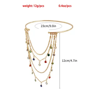 Gold-tone metal tassel arm cuff detail, multi-layered chain with colorful crystal drops.