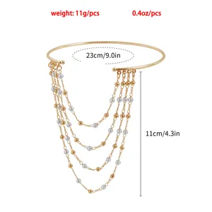 Gold multi-layer tassel arm chain with pearl accents, stylish upper arm bracelet jewelry.