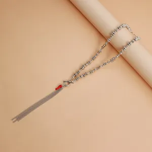 Vue détaillée du collier de perles irrégulières avec pendentif piment rouge et frange.