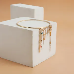 Exquisite gold-tone arm bracelet featuring retro tassel, cross and multi-element charms.