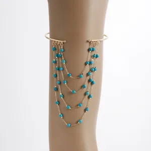 Gold multi-layer arm cuff chain with blue turquoise beads for women summer fashion.