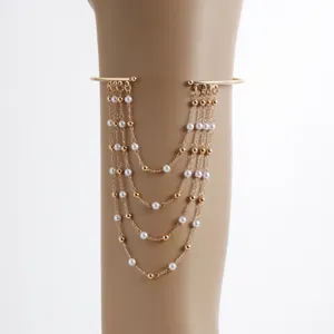 Gold multi-layer tassel arm cuff bracelet with elegant pearls and beads for women fashion style.