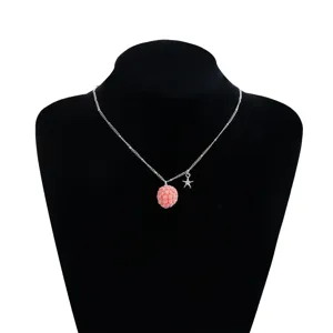 Silver chain necklace featuring a pink textured raspberry pendant and a sweet star charm.