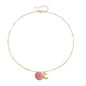Elegant gold chain necklace featuring a cute pink raspberry and shiny crescent moon pendant.