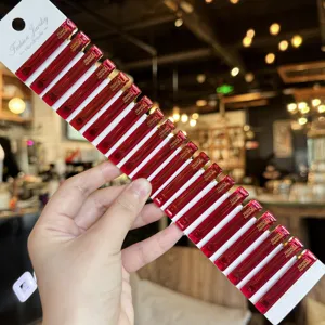 Close-up of red transparent acrylic duckbill hair clips set on display card, fringe side clip.