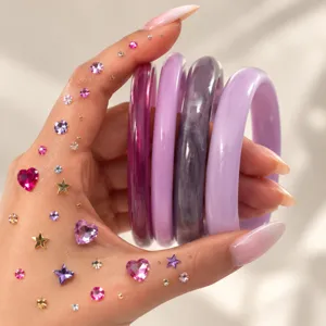 Colorful translucent resin bangles detail shot, glossy minimalist curved acrylic bracelets.