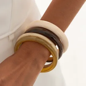 Resin bangle bracelet set with marbled multicolored design for women stacking jewelry style.
