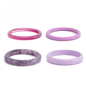 Detailed view of colorful resin bangles, fashion translucent purple stackable bracelets set.