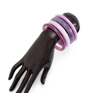 Detailed closeup of colorful resin translucent bangles set on a black display hand model.