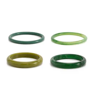 Green resin translucent fashion bangles detailed view showing colorful stained smooth surface.