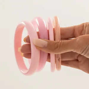 Colorful resin bangle set, trendy stacked transparent smooth wristbands for women detail view.