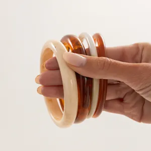 Detailed view of colorful gradient resin bangles set, smooth surface and stylish design.