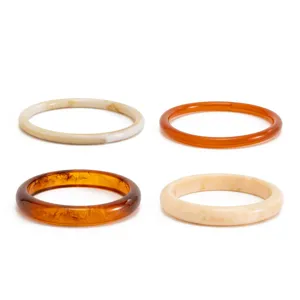 Colorful mottled transparent resin bangles set, smooth arc surface, fashion minimalist style detail shot.
