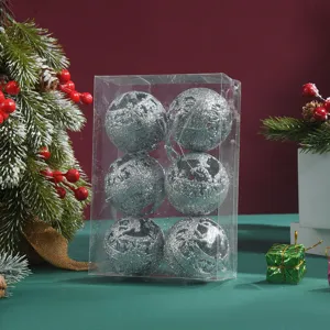 Detailed view of silver glitter Christmas balls with hollow deer design in clear box.