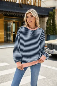 Detailaufnahme des gestreiften Pullovers mit Rundhalsausschnitt und kontrastierenden Bündchen.
