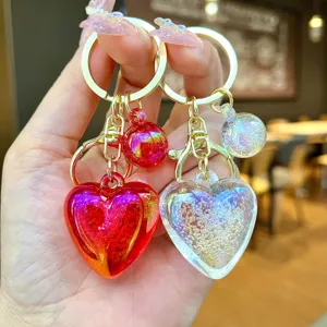 Detalle de primer plano del llavero de corazon con burbujas iridiscentes y colgante de bolso.