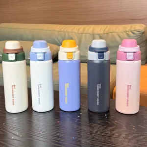 Detailed view of colorful stainless steel dual-drinking thermal water bottles in five tones.
