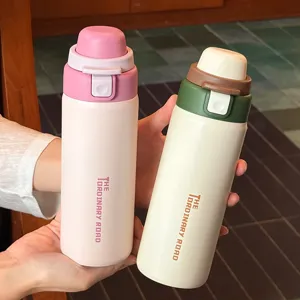 Detailed shot of portable stainless steel dual-drink thermos cups in pink and green.