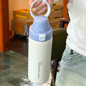 Close-up detail of portable stainless steel insulated water bottle with dual-drinking pop-up lid.