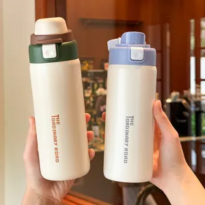Stainless steel double drink thermos cup detail view showing portable pop up lid design for students.