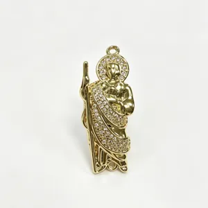 Gold-plated religious pendant charm close-up with sparkling zircon stones for DIY necklace making.