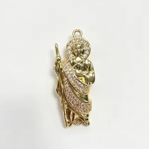 Detailed close-up of gold plated saint pendant with micro inlaid colorful zirconia stones.