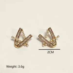 Gold geometric pearl crystal earrings detail view, showing fine design and sparkle.