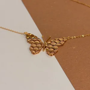 Gold honeycomb butterfly necklace with delicate 18k plated chain for stylish daily commute wear.