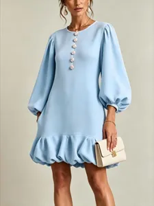 Light blue long sleeve round neck dress with floral buttons and bubble hem details.