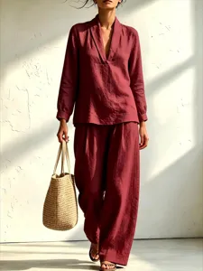 Close-up detail of the casual long-sleeve V-neck shirt and wide-leg trousers in burgundy.