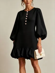 Close-up detail of the elegant black dress featuring unique floral buttons and lantern sleeves.