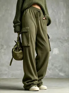 Olive green cargo sweatpants detail featuring elastic drawstring waist and wide leg cut.