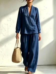 Stylish casual blue two-piece set featuring a long sleeve V-neck shirt and wide-leg pants.