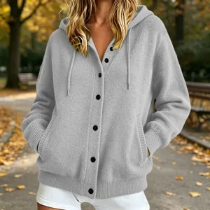 Close-up view of the cozy grey knitted hooded cardigan, featuring front button closure and pockets.