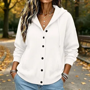 Close-up view of the white knitted hooded cardigan featuring black buttons and cozy pockets.