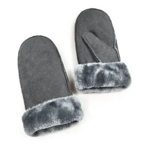 Close-up of cozy women winter warm faux fur lined mittens detail showing soft grey suede texture.