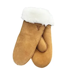 Keep warm this winter with these cozy brown shearling sheepskin mittens featuring plush white cuffs.