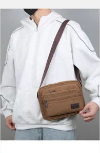 Men's casual canvas shoulder crossbody bag detailed view showing multi-layer zipper pockets.