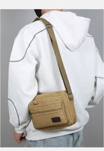 Close-up detail of the multi-layer casual canvas shoulder bag, showing durable khaki fabric and pocket.