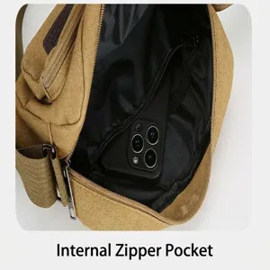Detail shot showing the interior zipper pocket and spacious canvas cross-body bag design.