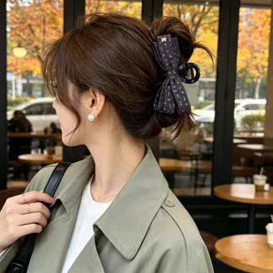 Détail rapproché de la pince à cheveux nœud en tissu rétro avec imprimé floral chic et élégant.