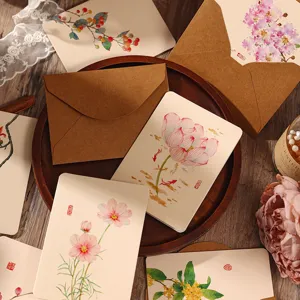 Detailed shot of Chinese vintage watercolor greeting cards with kraft envelopes and floral art.