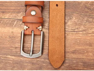 Détail de ceinture en cuir pour homme avec texture de vachette, boucle rétro et coutures.