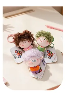 Detailed view of cute curly hair plush doll keychains with colorful hair and tags.