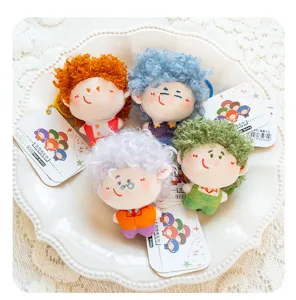 Detailed view of cute fluffy curly hair doll plush pendants, sweet girl backpack charms.