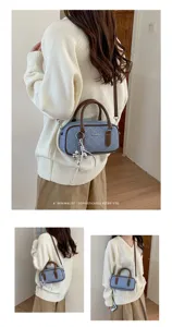 Detail view of the stylish quilted denim pillow bag with top handle and crossbody strap.