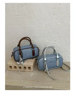 Denim quilted pillow handbag with chic charms, versatile commuter shoulder bag for autumn style.